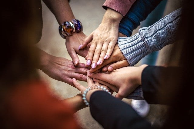 hands of team huddled together